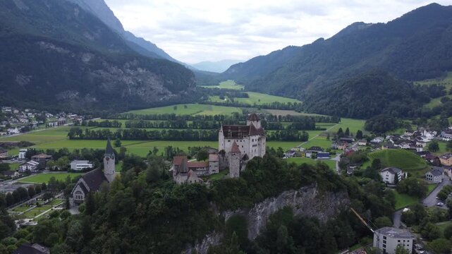 Drone film over castle in liechtenstein sour rounded by mountains