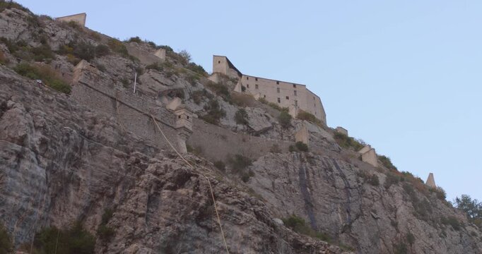 Low-angle view of Entrevaux medieval village's Entrevaux Citadel as castle on the limestone hill, Entrevaux, France