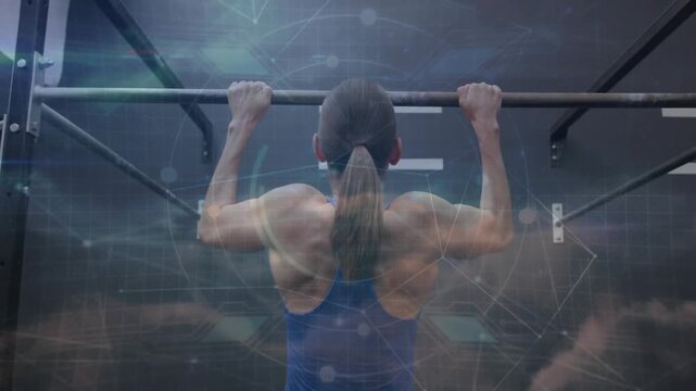 Female athlete gripping pull-up bar pulling up engaging lats as tech overlay shows fitness training