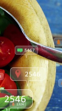 Vertical video: Camera panning, bowl with basil, tomatoes getting floating callouts for food tech
