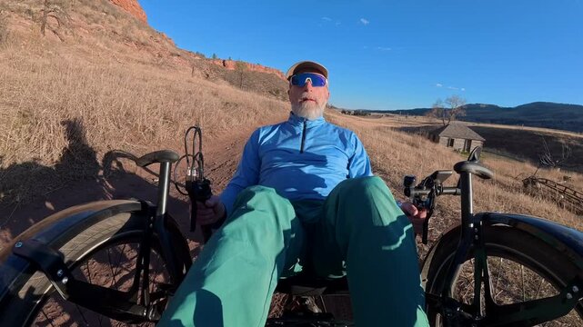 Senior cyclist is riding a full suspension recumbent on a rough mountain trail in northern Colorado foothills - Bobcat Ridge Natural Area