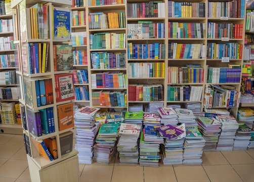 Serik, Turkey - March 27, 2026: Interior of cozy Turkish bookstore with wooden shelves packed with colorful educational books, textbooks, literature stacks for students and avid readers