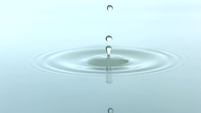 Water droplets falling into water in high-definition, beautiful slow-motion close-up footage