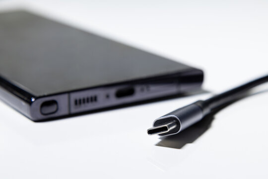 USB Type C cable with smartphone charging port on white background