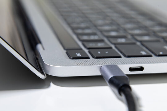 USB Type C cable plugged into laptop side port close up