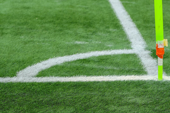 soccer field with green grass, white markings, and a corner flag.. The image captures part of the pitch used in professional matches, highlighting sports atmosphere and game preparation