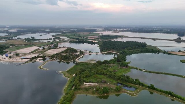 Aerial view captures abandoned tin mines of Kampar, now filled with reflective pools and greenery.