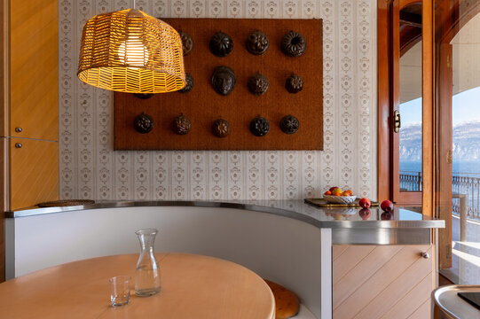 Cozy retro kitchen nook with rattan lamp and lake view