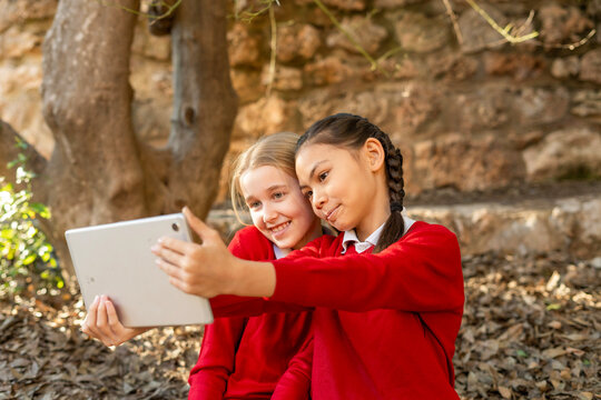 Friends taking a selfie outdoors in autumn scenery