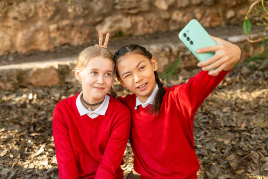 Friends taking a selfie in red sweaters