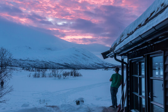 Snowy mountain dusk by cabin near Tromso, Norway