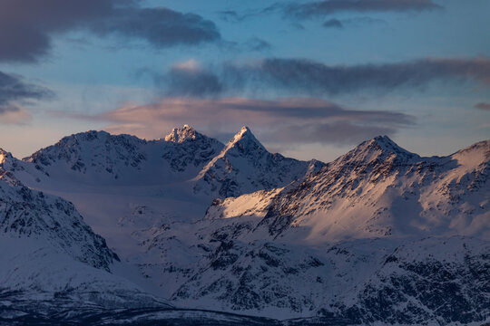 Snowy mountain peaks at twilight near Tromso, Norway