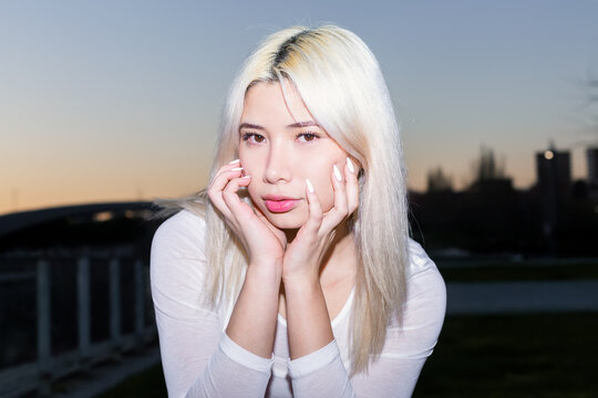 Flash portrait of platinum-haired Gen Z girl in streetwear