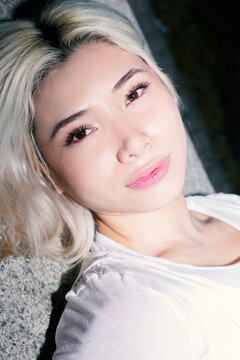 Flash portrait of Gen Z girl with platinum hair closeup