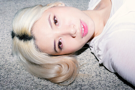 Flash portrait of Gen Z girl with platinum hair closeup