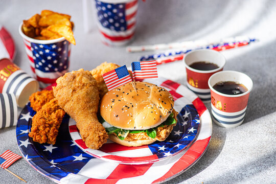 Independence Day party food with burger, wings and cola