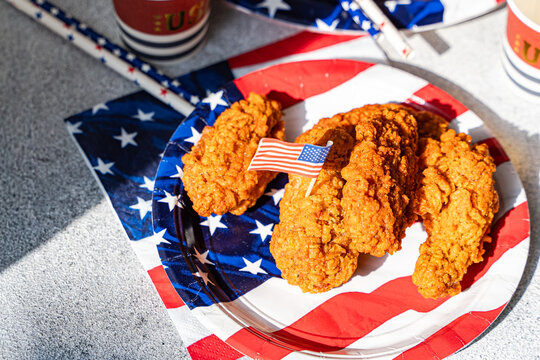 Fried chicken wings on patriotic plate for USA party