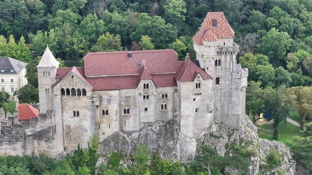 Aerial of Burg Lichtenstein fortress in scenic natural Austrian landscape.