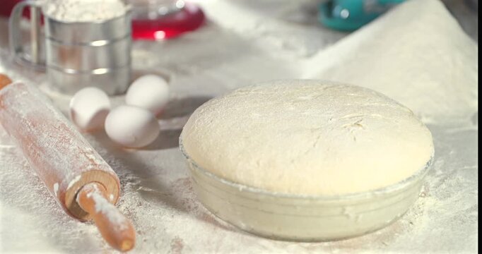 Timelapse footage Yeast Bread Proofing Process Visualization. Bowl Of Fermenting Bread Dough With Baking Tools