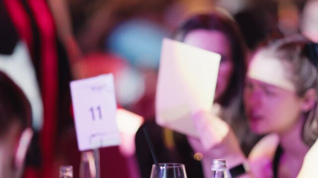 Participants focus intensely while auctioneer conducts lively bidding process