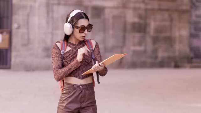 Happy university student dancing and listening to music