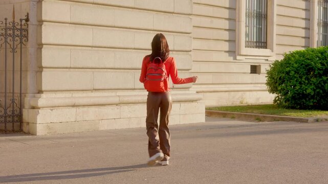 Joyful tourist dancing while walking through Madrid streets. Almudena Cathedral
