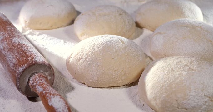 Timelapse footage Rapid Video Capture Of Dough Mounds Proofing On Floured Surface With Rolling Pin And Studio