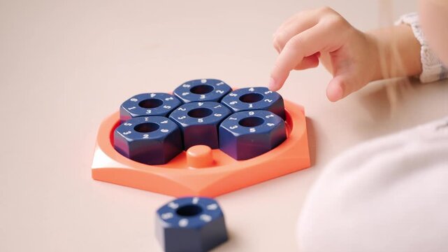 girl solving logic puzzle, Children hands playing with educational math STEM game using pieces learning number composition seven practicing logic thinking fun cognitive activity and math skills