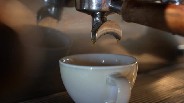 Fresh Espresso Pouring from Portafilter into Cup Close Up with Crema