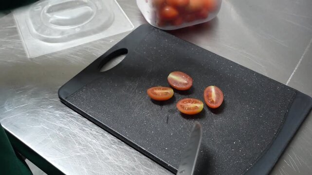Fresh Tomatoes Being Sliced on Black Cutting Board Close Up