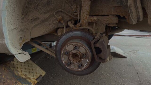 Sincere depiction of roadside vehicle repairs with tools and worn parts