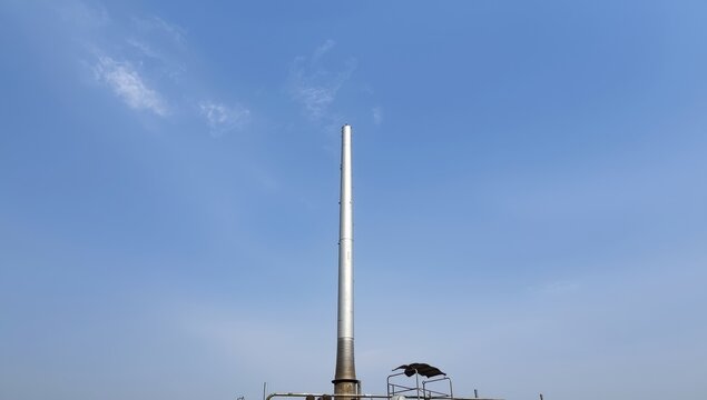 An upright chimney at a crematorium for smoke emission.