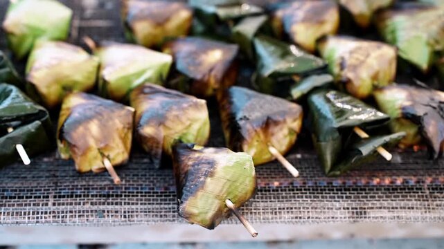 Grilled Sata banana leaf parcels on skewers
