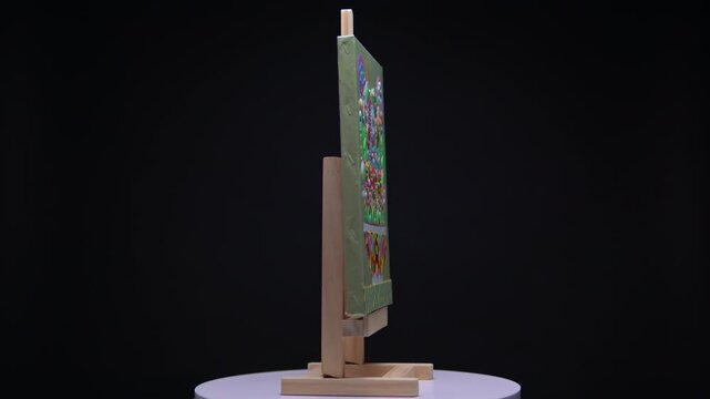 Tactile sensory textured handmade still life floral artwork rotating on display easel. Flowers made of recycle paint with a lot of details and thick layered acrylic pigments on canvas.