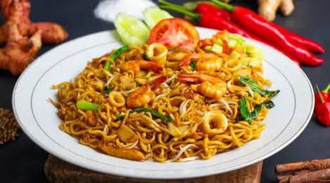 Ai Generates Spicy stir-fried noodles with vegetables and seafood, classic Indonesian street food mie goreng. Perfect for fast food, street culinary, and vibrant food content.