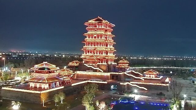 A stunning multi-story Chinese pagoda glowing with golden lights against a dark night sky, showcasing urban night life.