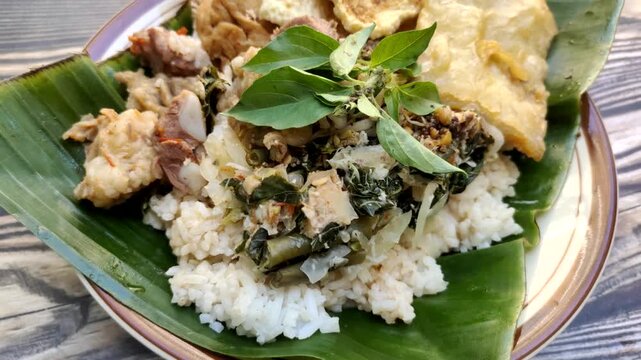 "Nasi Tumpang Lethok Koyor" or Rice with fermented tempeh sauce is a delicious local dish from Klaten, Central Java, Indonesia.