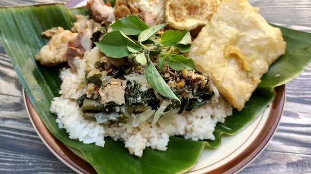 "Nasi Tumpang Lethok Koyor" or Rice with fermented tempeh sauce is a delicious local dish from Klaten, Central Java, Indonesia.