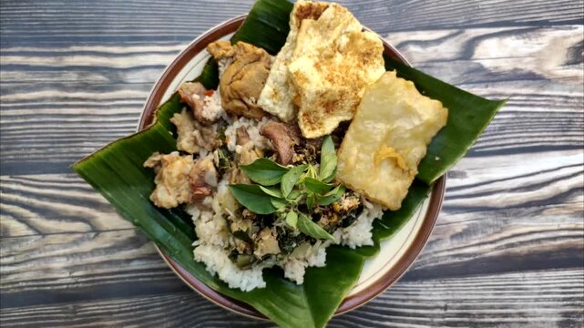 "Nasi Tumpang Lethok Koyor" or Rice with fermented tempeh sauce is a delicious local dish from Klaten, Central Java, Indonesia.