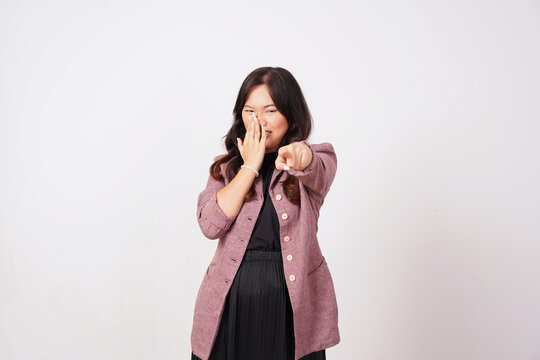 Cheerful woman laughing and pointing at camera