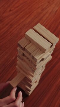 Skillful Hands Play Jenga, Removing Wooden Block