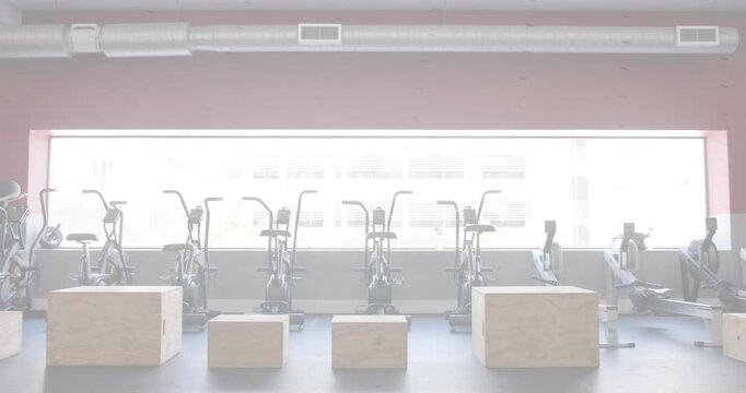 Cardio machines and plyo boxes staying in gym, window shifting diagonal band, altering exposure