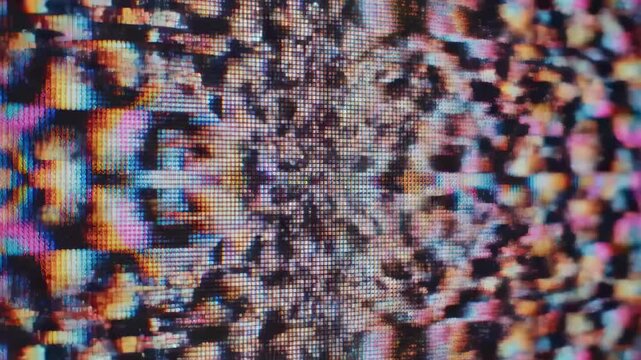 This displays a distorted error screen with glitchy pixels and vibrant colors, representing technical difficulties and digital chaos.