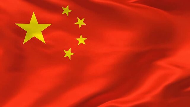 A bright red fabric banner featuring five yellow stars waving in the wind