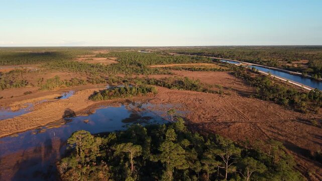 Push in drone shot of the John C. and Mariana Jones Hungryland Wildlife and Environmental Area in Palm Beach and Martin County showing the vast extent of the land including canals, ponds and prairies.