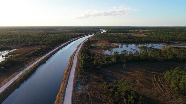 drone push in shot along a canal at John C. and Mariana Jones Hungryland Wildlife Environmental Area in Palm Beach and Martin County showing the diverse environment of water and prairie