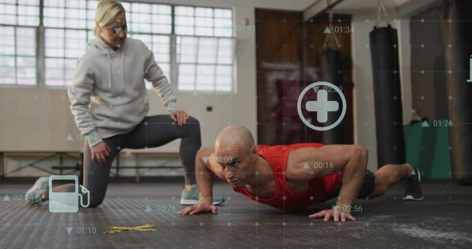 Coaching trainer cueing trainee in red tank doing pushups on gym floor for technique, HUD overlays