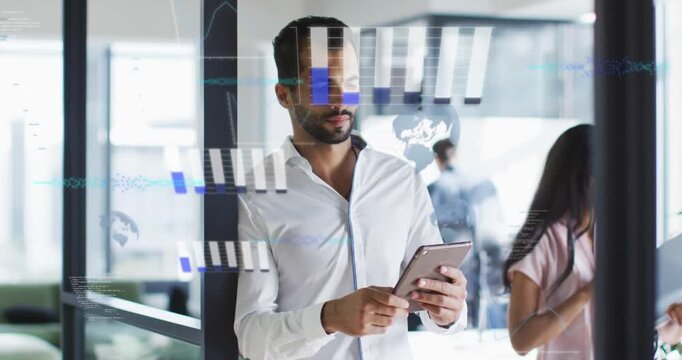 Man standing by glass tapping tablet and activating data overlays while reviewing analytics