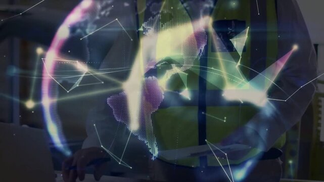 Engineer holding plans using laptop, activating network globe expanding over torso for construction