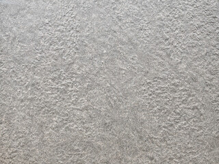Fototapeta premium High-resolution grey concrete background with fine natural grain. Raw cement plaster texture for architectural design, urban themes, and modern interior backdrop.
